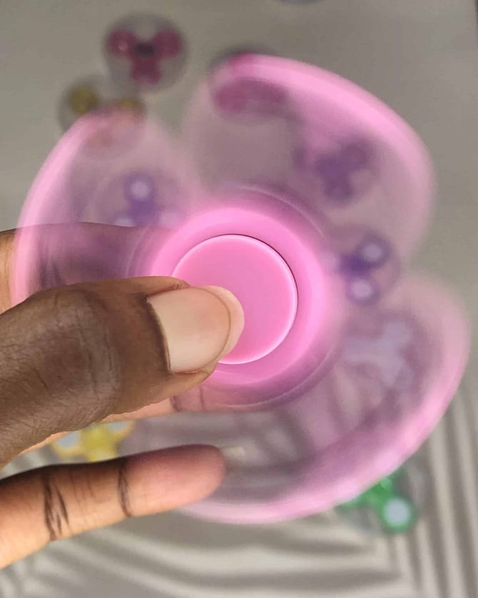 spinning pink plastic fidget spinner