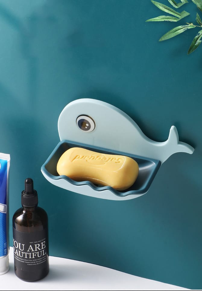 Blue fish-shaped soap holder on wall