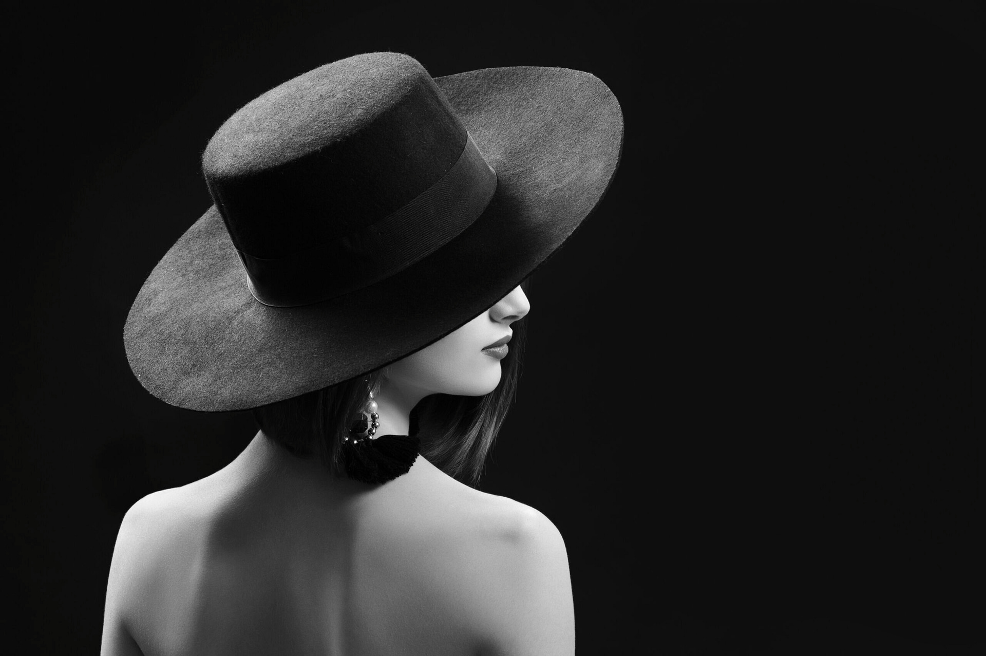 Black and white image of a woman wearing a hat